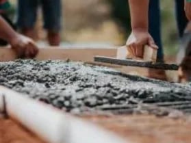 Building and Construction people laying cement