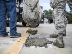 People laying down cement